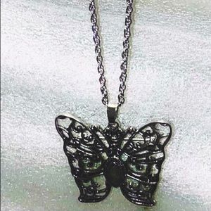 Butterfly necklace with purple stone in center